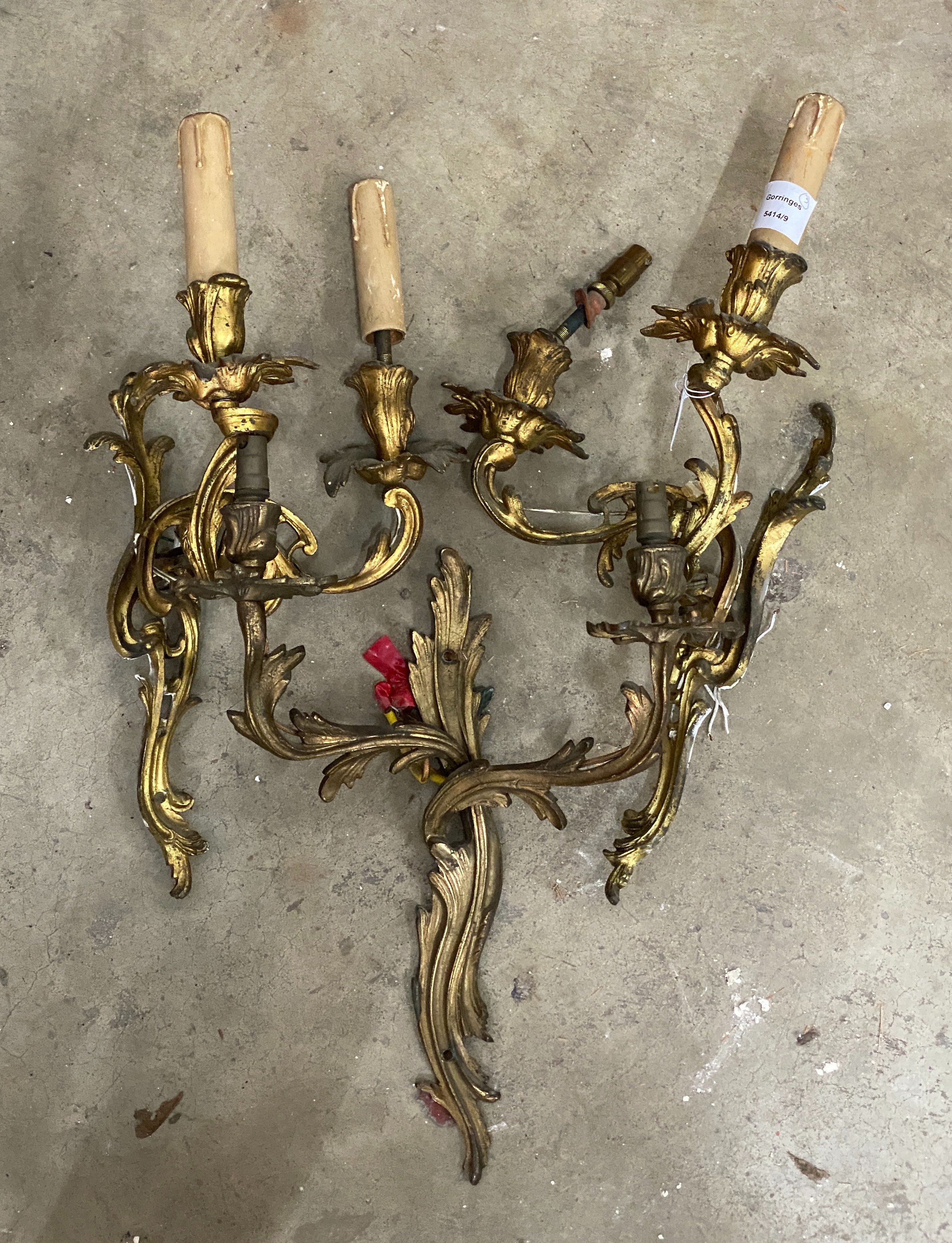 A set of three rococo style gilt metal twin branch wall lights, height 45cm